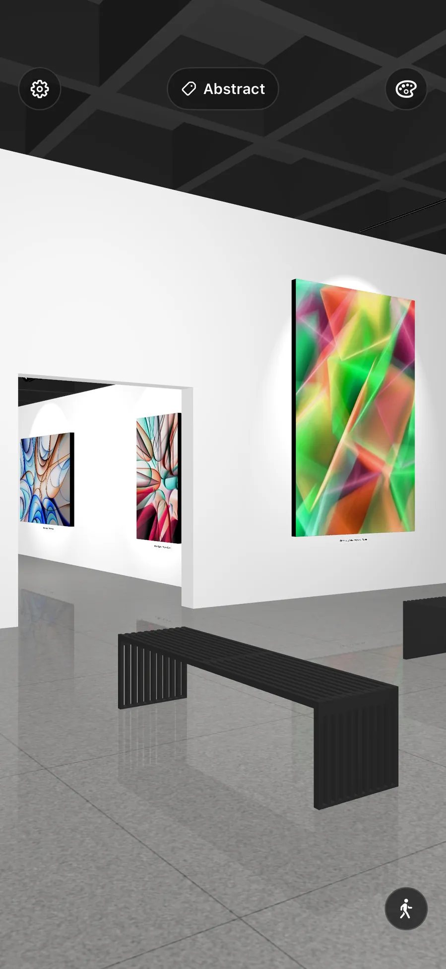 A long white gallery, canvases lit on both sides